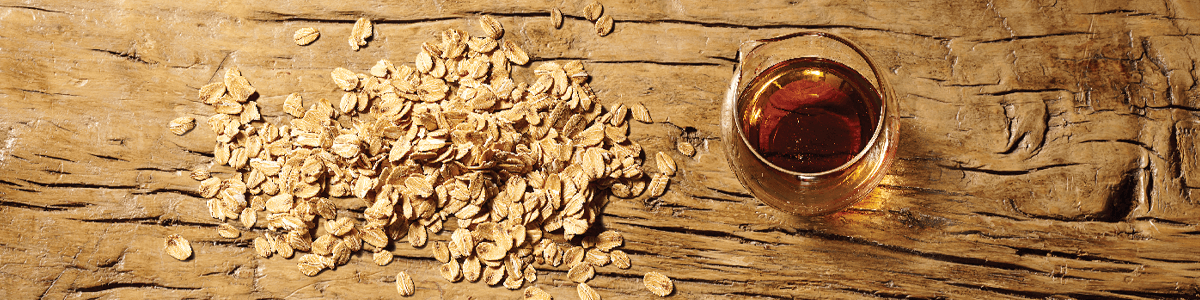 Oats and maple syrup ingredients on wooden table