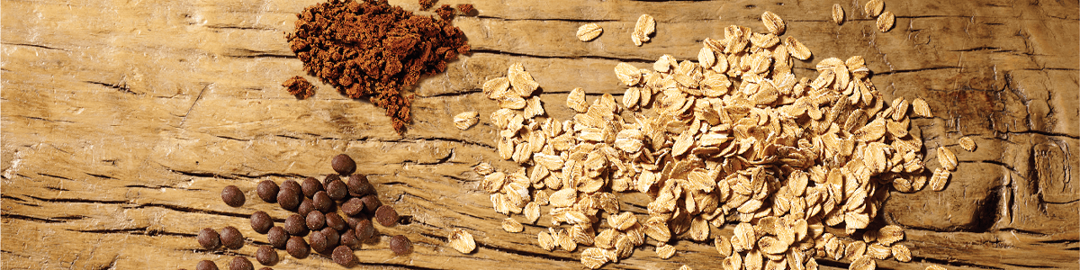 Dark chocolate and oats ingredients on wooden table