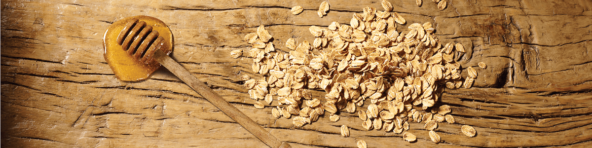 Honey and oats ingredients on wooden table