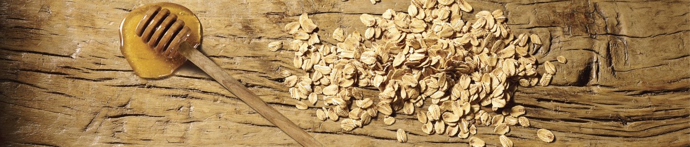 Honey and oats ingredients on wooden table