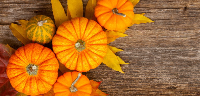 A close-up view of pumpkins arranged in an artistic and colorful display on a table.
