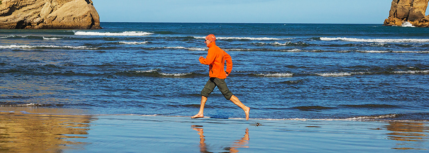 Man running on the see shore