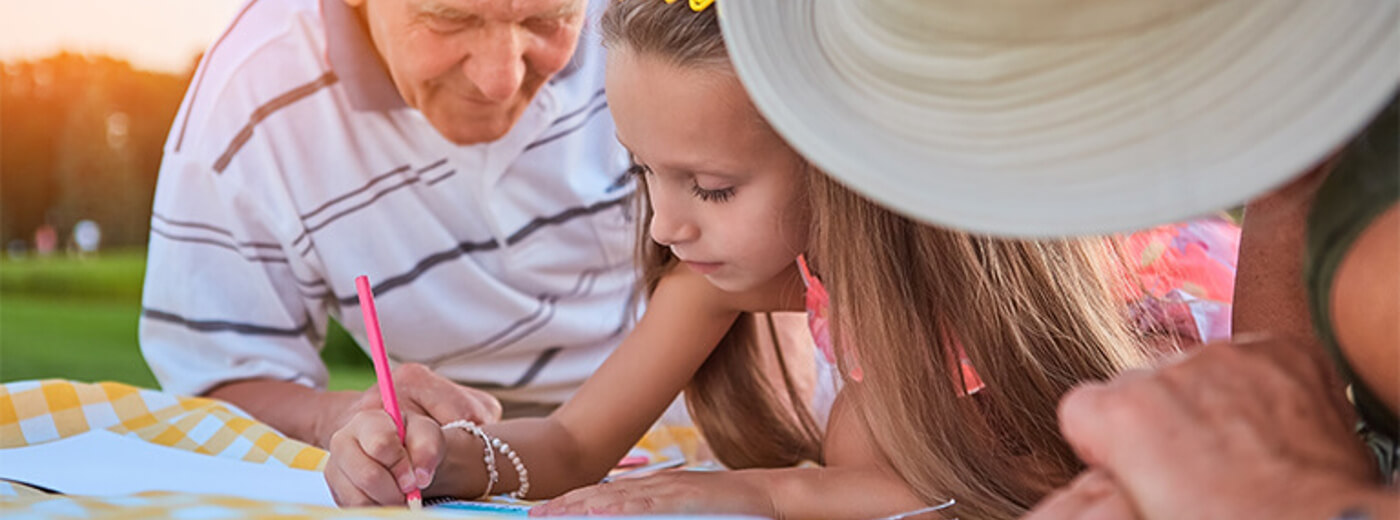 A group of family - a little girl writing a notebook.